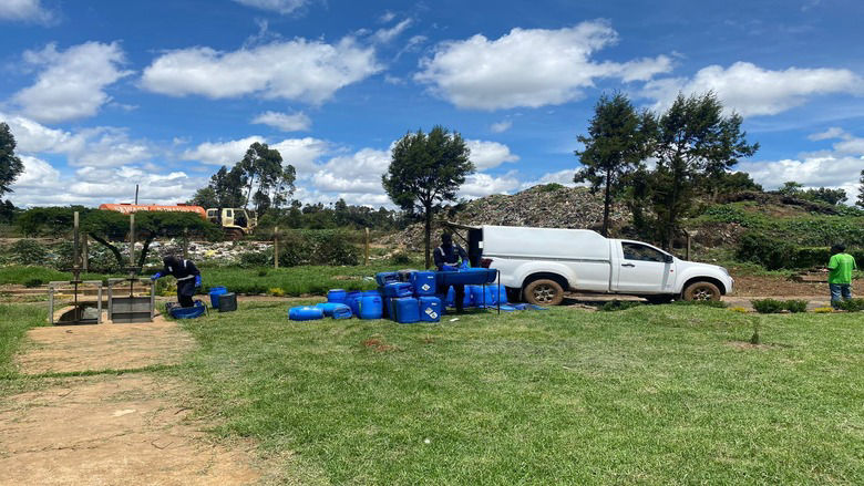 Sanitation workers clean waste collection 