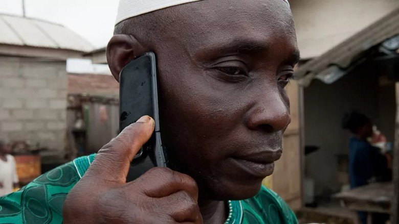 Raufu Alaka, chief in the fishing village of Orimedu in Lagos State is making a phone call