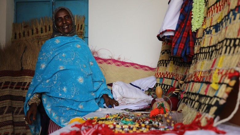 With help from a local savings group, Mariam turned a small clothing business into a thriving handicraft shop/ Mariam a trans