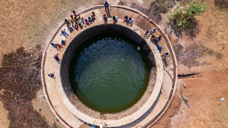 Villagers gather at a well in rural India. Photo: Shutterstock/Prabuddha
