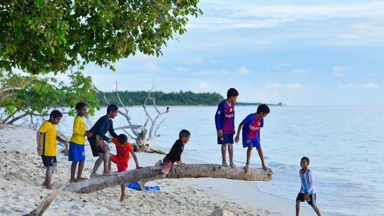 Children playing in the beach in the Maldives