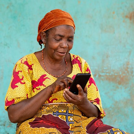 smiling senior African woman using her smartphone