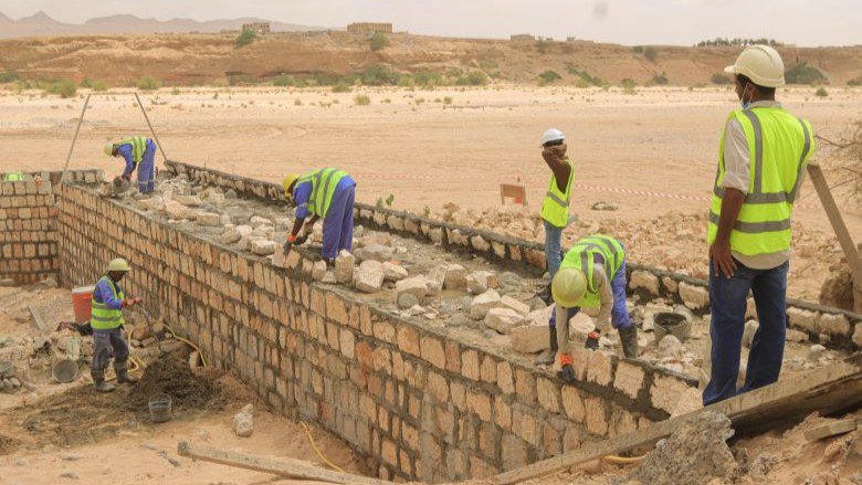 Construction workers building the irrigation channel and water barriers in Shabwah