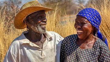 older african farming couple laugh together