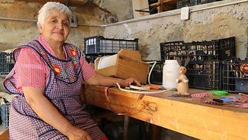 Older woman at a workbench