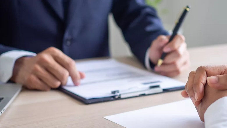 hands of interviewer and interviewee on the table during the meeting 