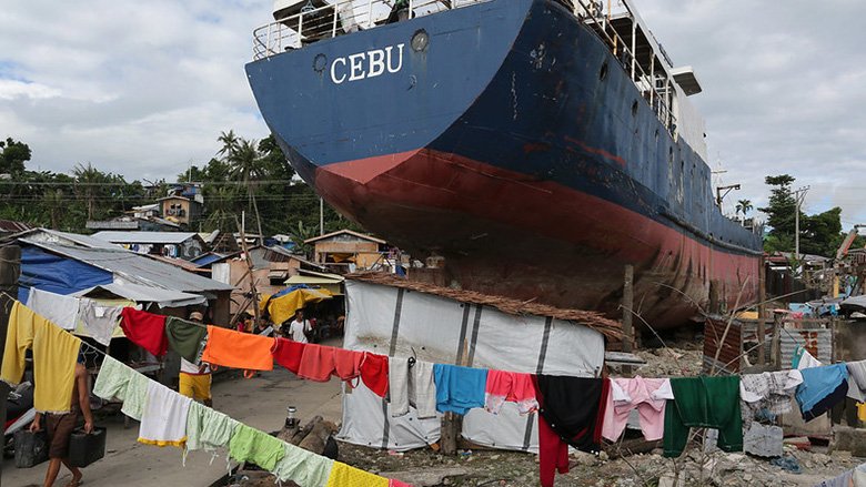 Residents affected by typhoon Haiyan (Yolanda) carry on with their daily activities