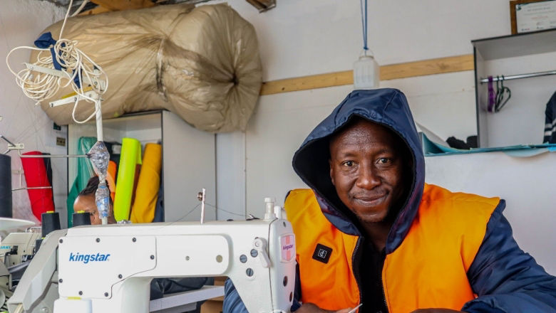 Owner of Lesotho Iconics business with a sewing machine