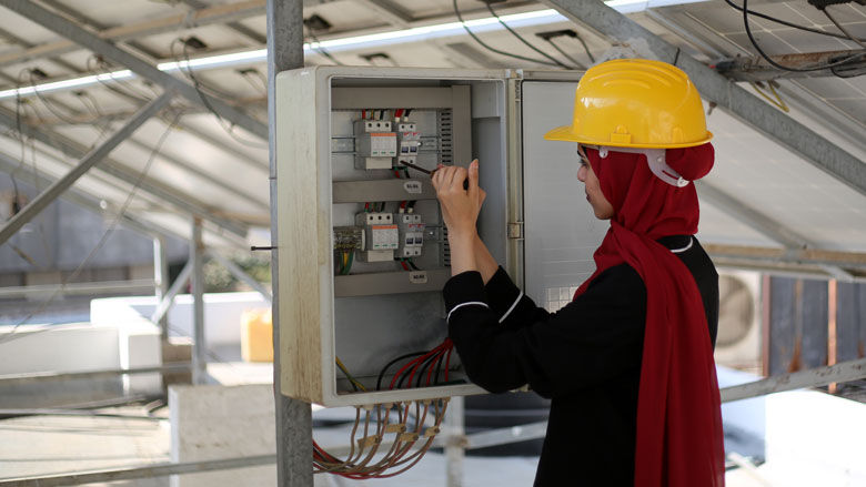  A Palestinian Engineer inspects solar panels on the roof of Al-Falah Medical Center, Gaza.
