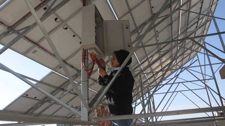 A young Palestininan lady working in solar PV installations in Gaza. 