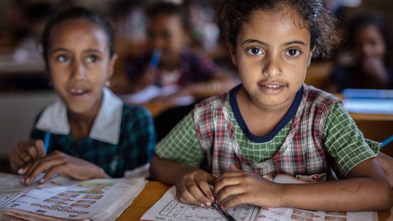 Two Yemeni girls attend classes at a school rehabilitated by the Yemen Emergency Crisis Response Project. 