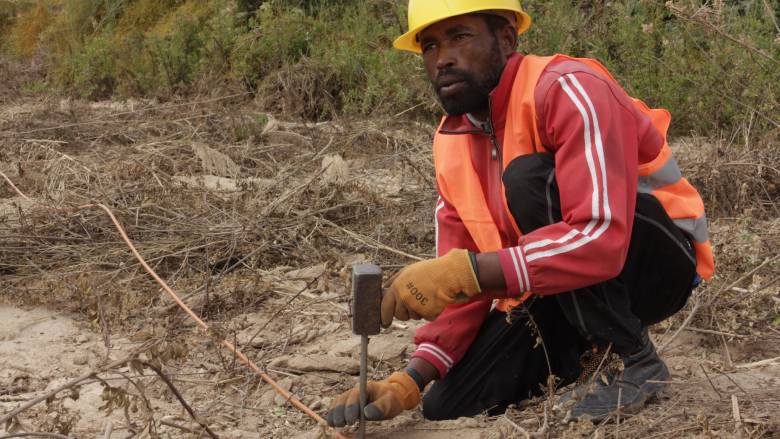 A surveyor installs groundwater sensors in Namibe, Angola.