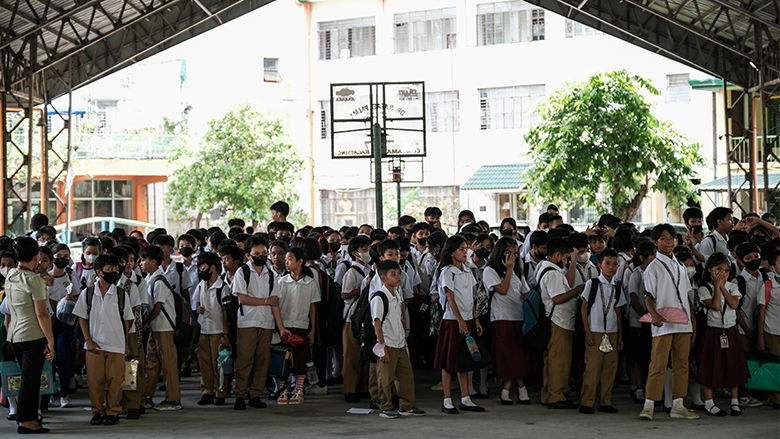 Students under a covered court in the Philippines