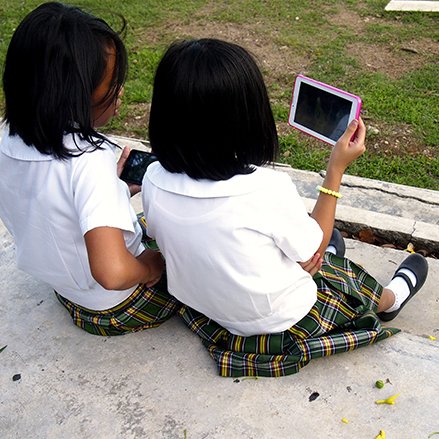 Philippines: two girls with their smartphone and tablet