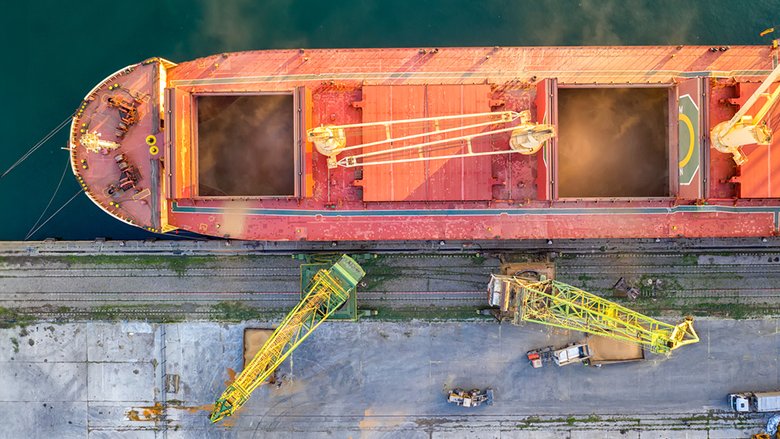 Aerial view of a large ship loading grain for export.
