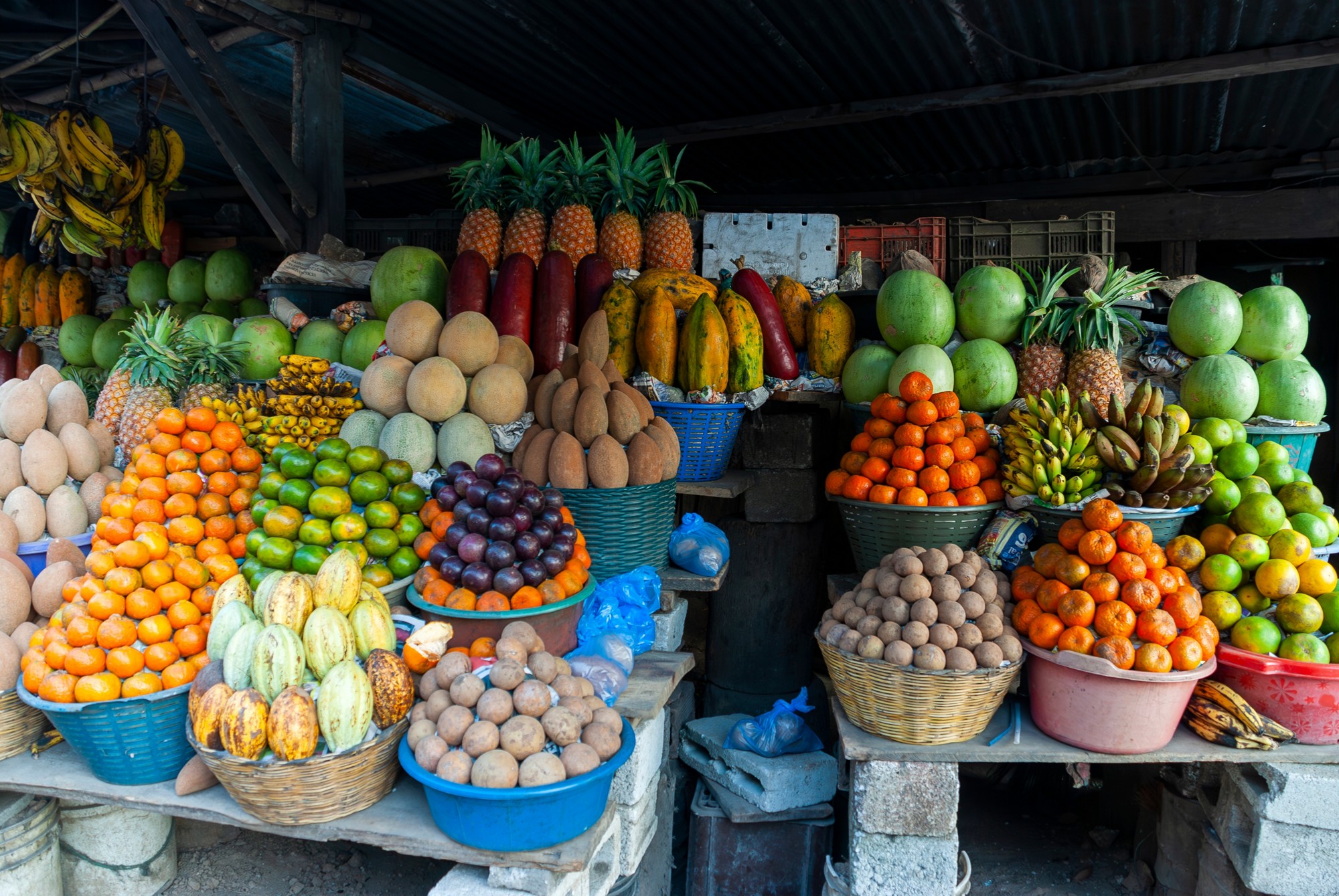Street sales in rural area of tropical fruits in Guatemala, informal economy space to generate livelihood for Latino families, fruits of bright colors and textures, commercial premises.