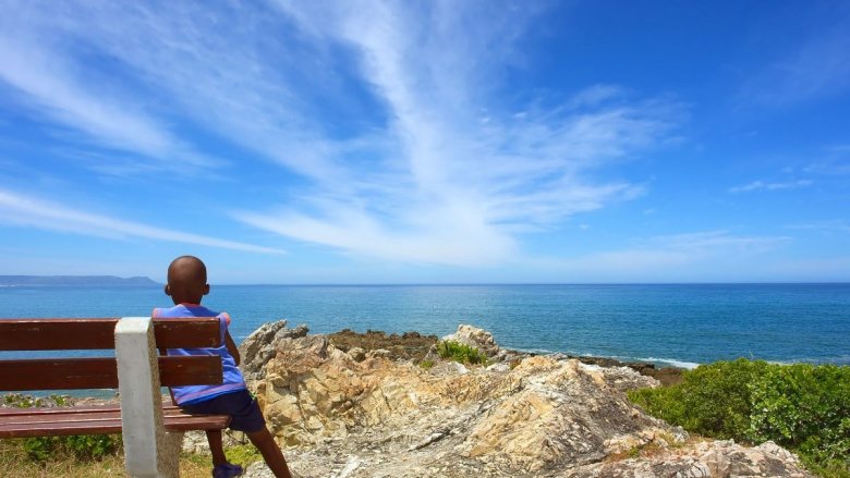 Boy in South Africa looking at the blue sky 