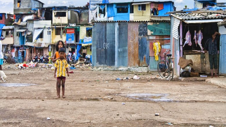 Children playing on a blank area of a slum in front of their homes in Mumbai, India. ? Shutterstock.com 