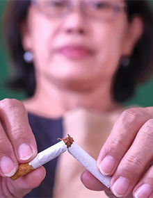 woman breaking apart a cigarette