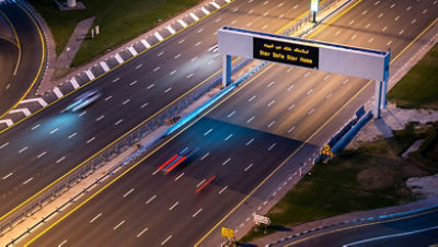 Empty highway in Dubai because on coronavirus. Sign advertising the Stay Home Stay Safe campaign.