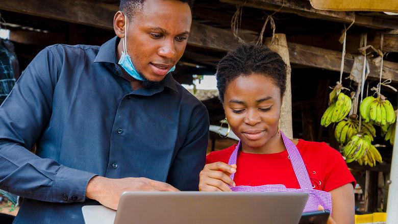 African lady working in a kiosk smiling