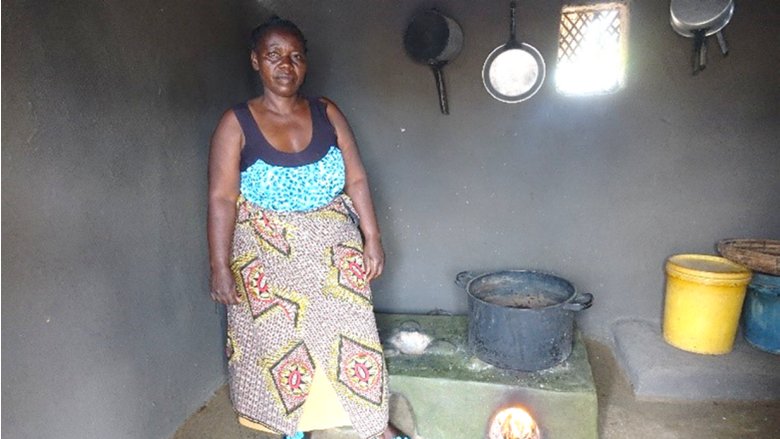 Lady in front of a stove in Zambia